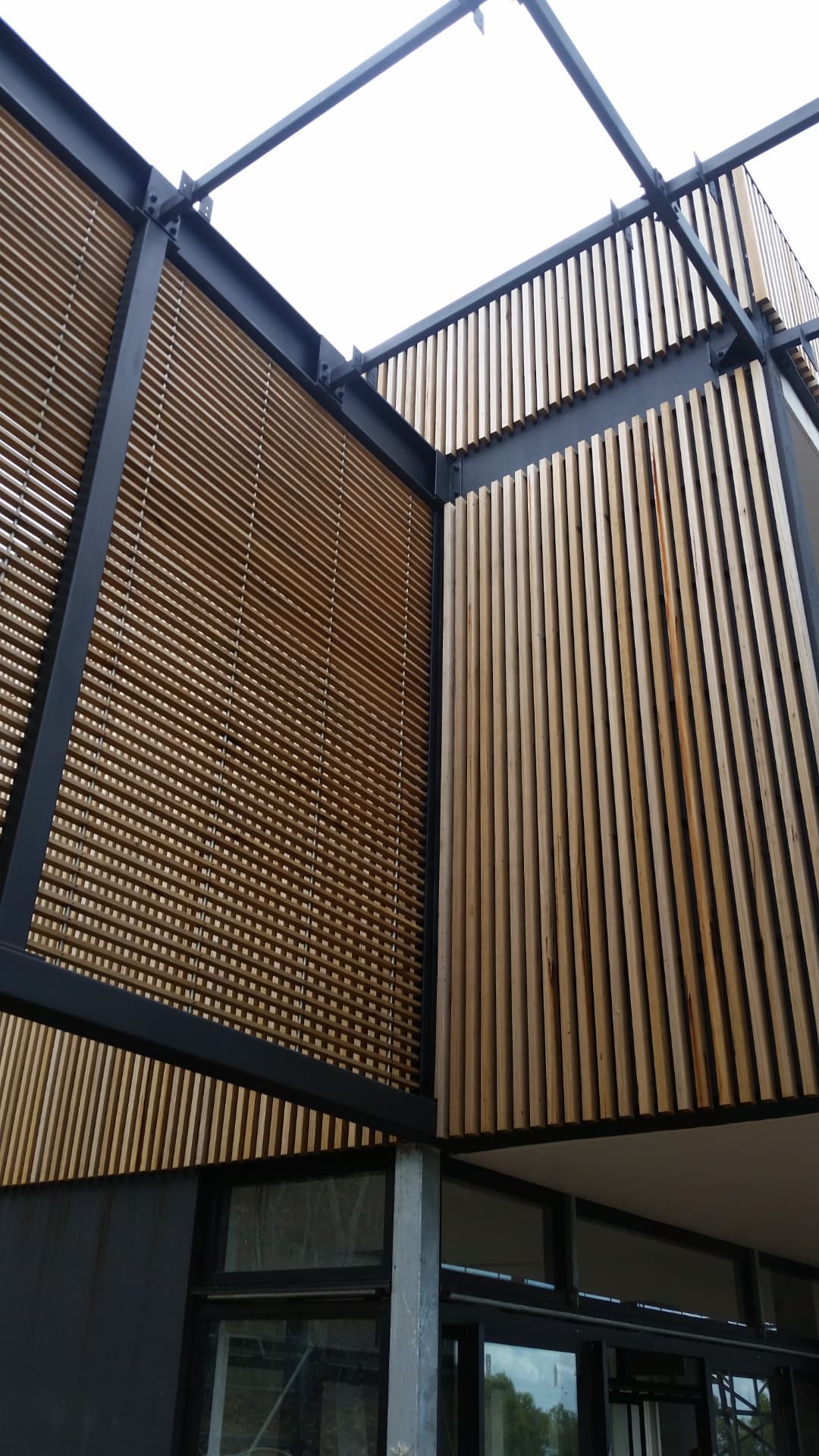 Timber batten screens framed into a black steel structure