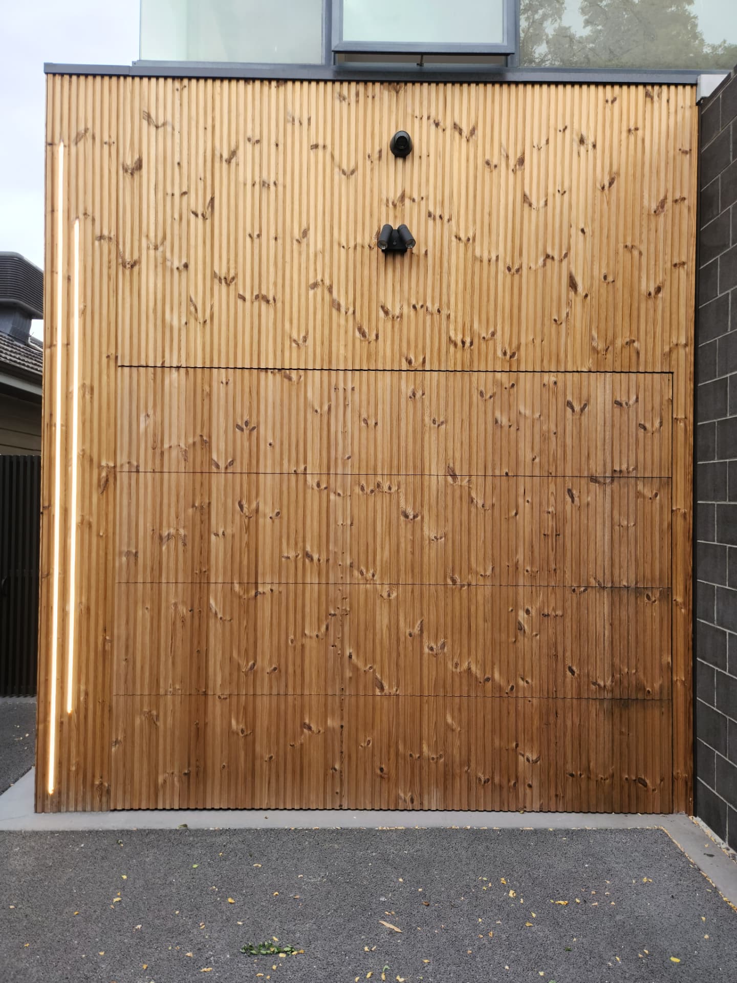 Finished cedar batten garage facade with recessed LED lighting