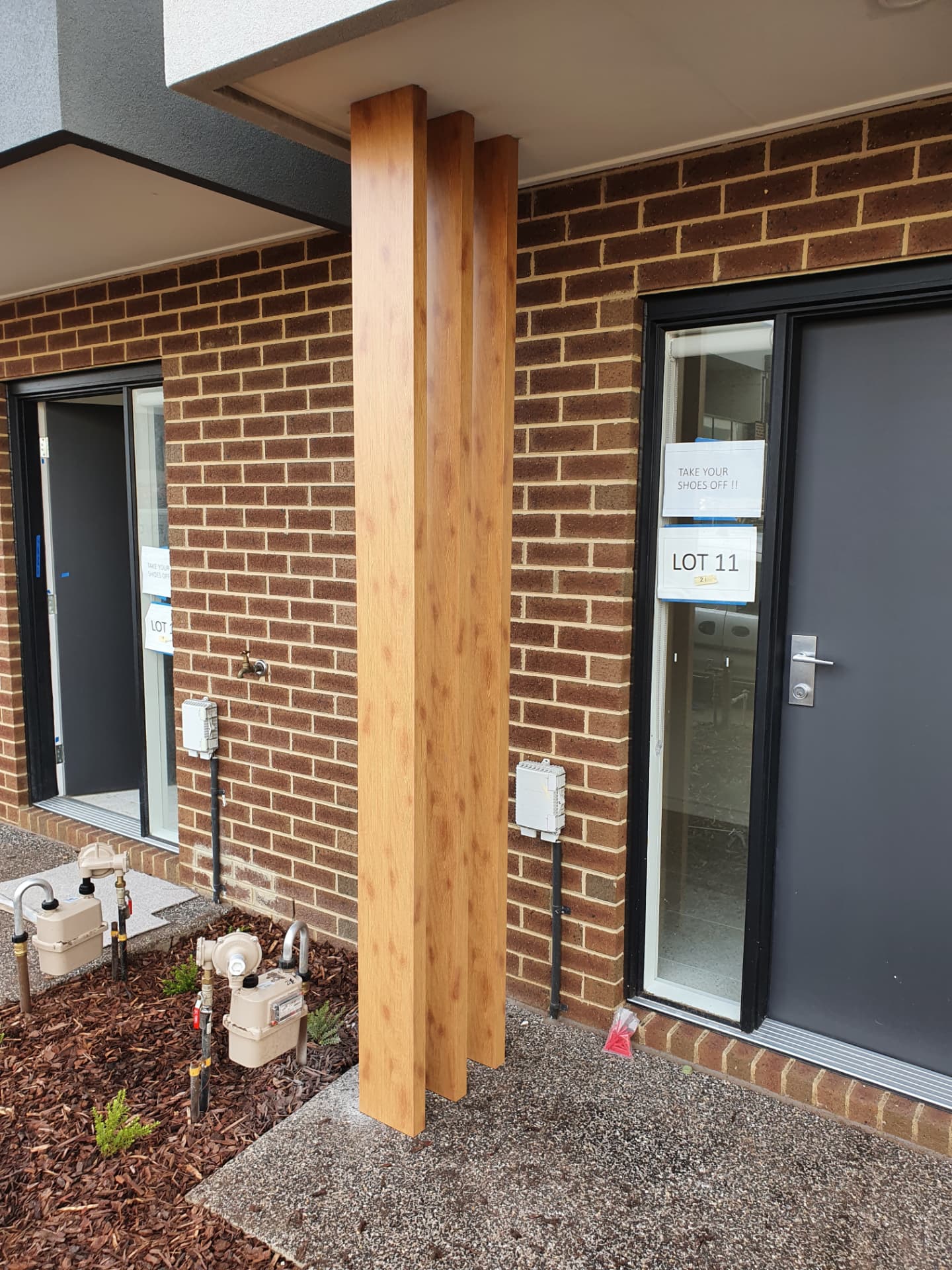 Timber-look entry posts installed to a new townhouse portico